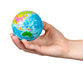 small model of the globe in the hand of the girl on a white back