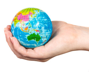 small model of the globe in the hand of the girl on a white back