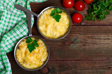 French cuisine. Сhicken with mushrooms baked with cheese in a cocotte