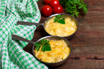 French cuisine. Сhicken with mushrooms baked with cheese in a cocotte