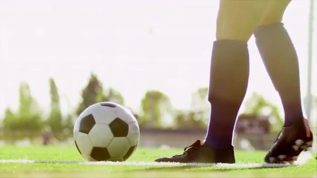 Close up of a soccer ball being kicked back into play