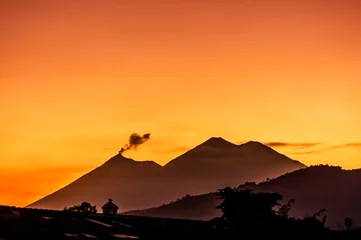 Tuinposter Fuego volcano & Acatenango volcano at sunset © Lucy Brown
