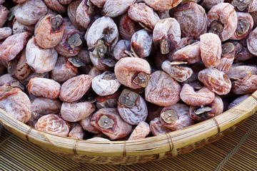 Basket of Hoshigaki air dried persimmon kaki fruit, a Japanese delicacy