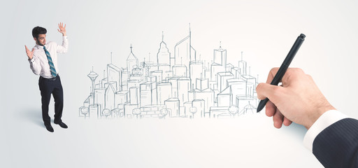 Businessman looking at hand drawn city on wall