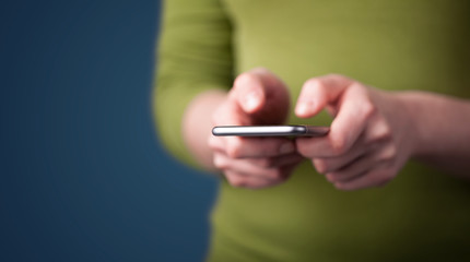 Young woman holding smarthphone in hand