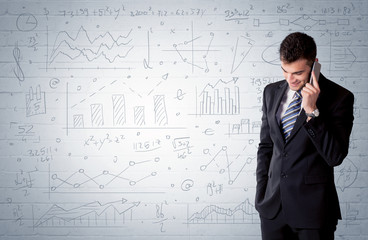 Salesman standing with drawn graph charts