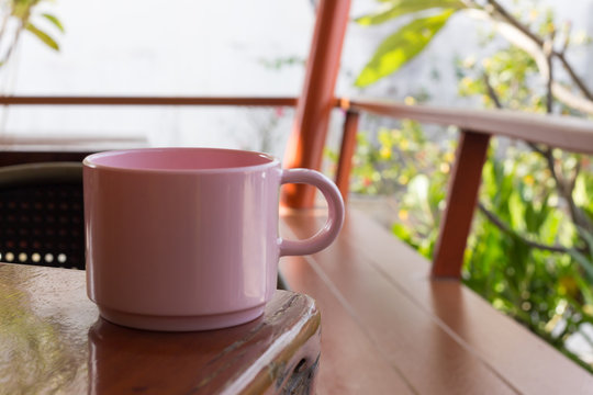 Pink Coffee Cup Placed On A Wooden Table