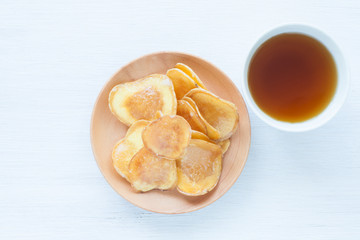 Dried potato slice and  coated with sugar