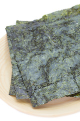 Nori , Japanese edible seaweed used as a wrap for sushi and onigiri