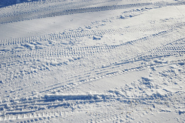 tire tracks on street after snow