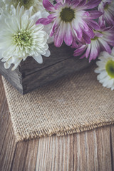 flowers on tray and sackcloth with blank space in vintage tone