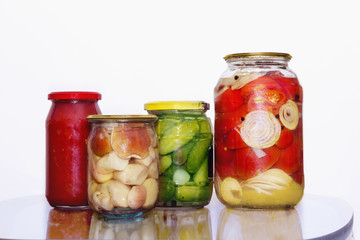 Mushrooms and vegetables in glass jars
