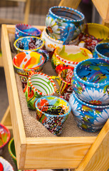 Collection of colorful cups for sale at the bazaar