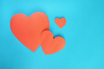 Red hearts paper on cyan paper background for Valentines day
