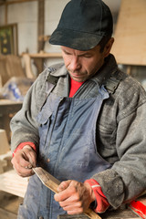 Carpenter holding a wooden piece of furniture