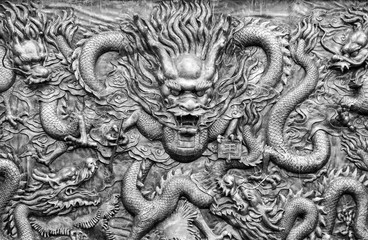 Ancient bronze dragons carving in the ancient Dragon King Temple along Yangtze River,China. Foreign text means King. - 100861913