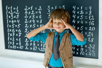 Schoolboy near blackboard 