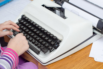 Cute little girl typing letter