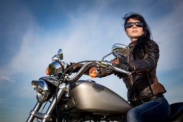 Obraz na płótnie Canvas Biker girl on a motorcycle