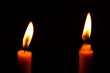 light of candle on black background