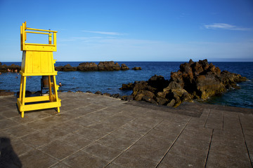 yellow lifeguard chair cabin  in lanzarote  spain   rock stone s