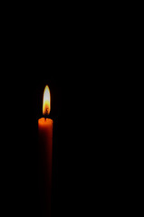 light of candle on black background