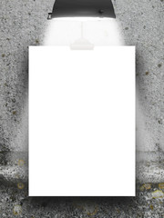 Close-up of one hanged paper sheet frame with lamp on weathered wall background