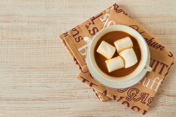 Cup of hot cocoa with marshmallows on the wooden table, top view