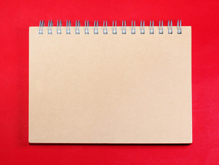 Top view of brown blank note on red background