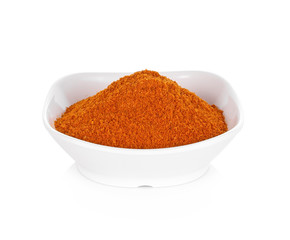 Powdered dried red pepper in a white bowl on white background