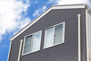 Detail of house exterior wall and window..