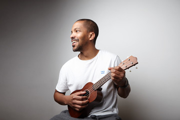 Black young man with ukulele