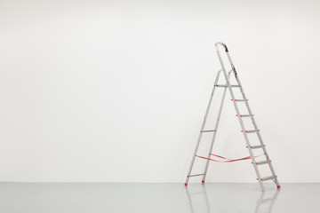 Ladder with white wall, construction site