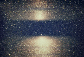 glitter vintage lights background. light silver, gold, black. defocused.
