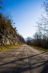 Mountain path with rocks and trees in the roadside