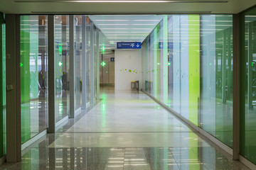 Connecting corridor in green glass hall.