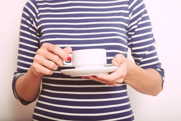 Cup of tea in hand with steam