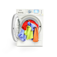 A close up of a washing machine loaded with clothes isolated on
