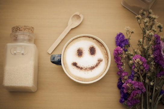 hot coffee with foam milk art smile pattern