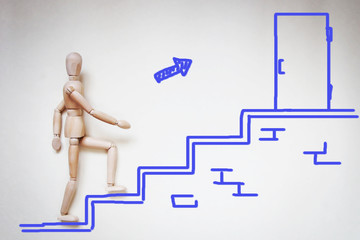 Man going upstairs to the door. Abstract image with a wooden puppet