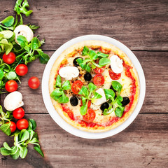 Pizza with cheese, mushrooms and olives, top view