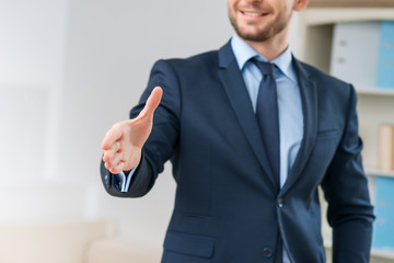 Positive office worker welcoming you 
