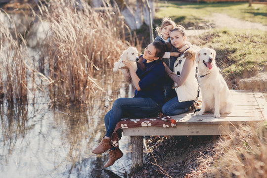 Happy Family With Pets Near The Lake