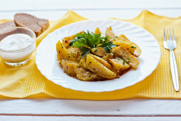 beautiful roasted potatoes with herbs and spices on a white plate