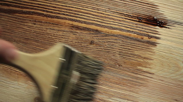 Wood painting with a brush with the brown color
