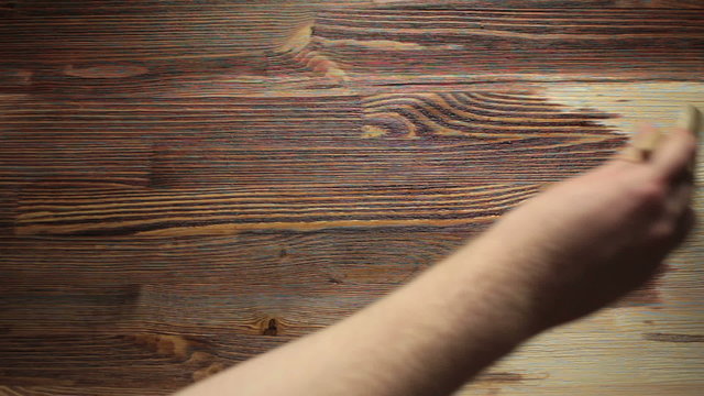 Paint brush painting  wooden table with wood stain
