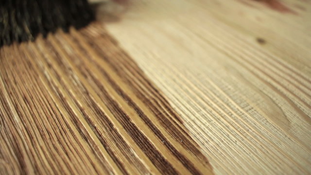Wood painting with a brush with the brown color