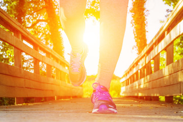 Woman running at sunset in a field