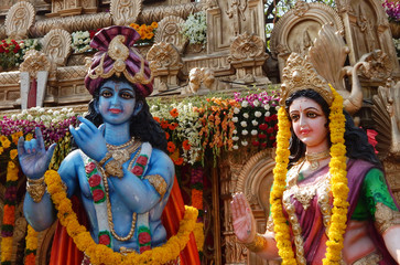 Fototapeta na wymiar People install Idols of Hindu gods Krishna and Radha in a pandal on the Hanuman Jayanti day in Hyderabad,India.