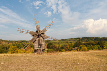Plakat Ancient wooden windmill in a meadow. Ukraine, Pirogovo